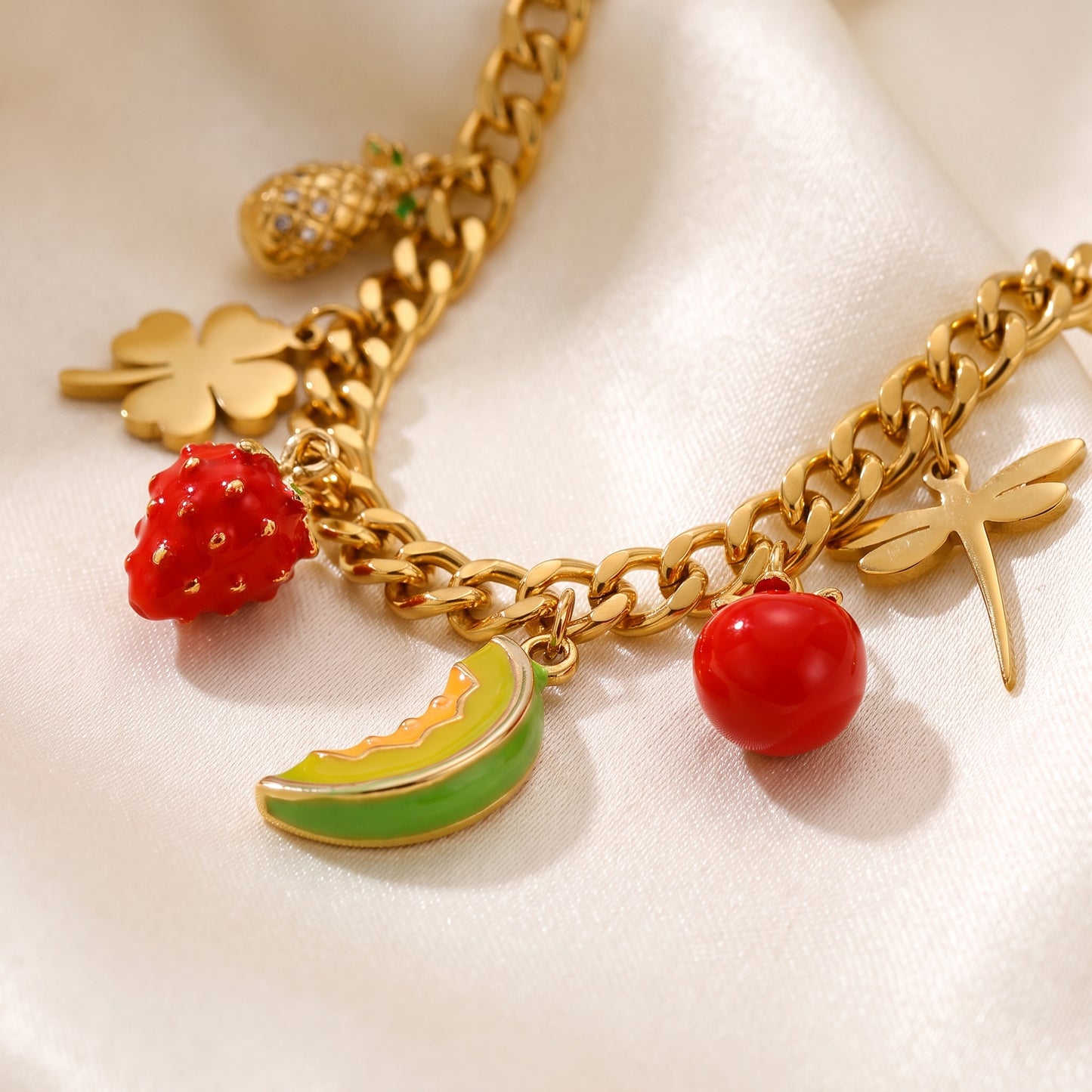 Close up detail of Floravisha Verona gold necklace showing secure clasp, tarnish free finish, and red strawberry fruit charm.