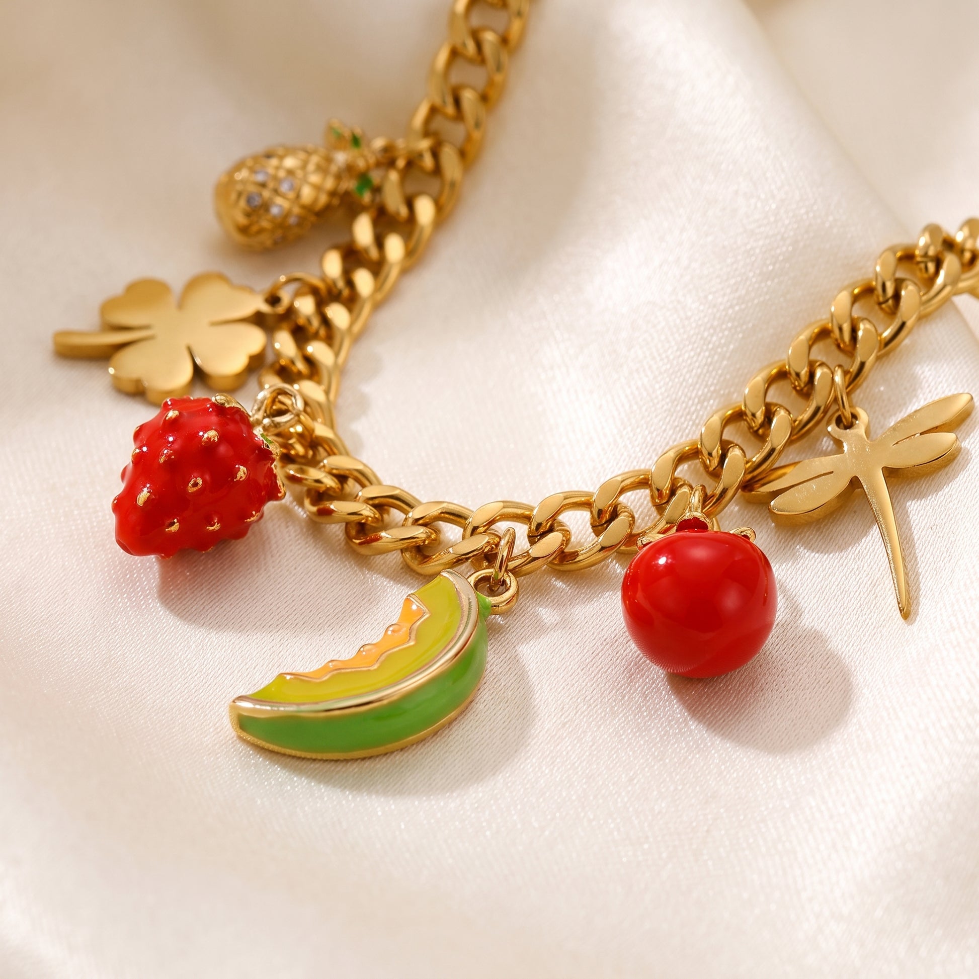 Close up detail of Floravisha Verona gold necklace showing secure clasp, tarnish free finish, and red strawberry fruit charm.