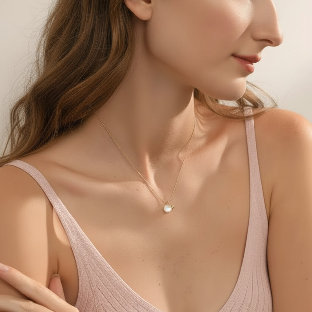 necklace with a pearl pendant.