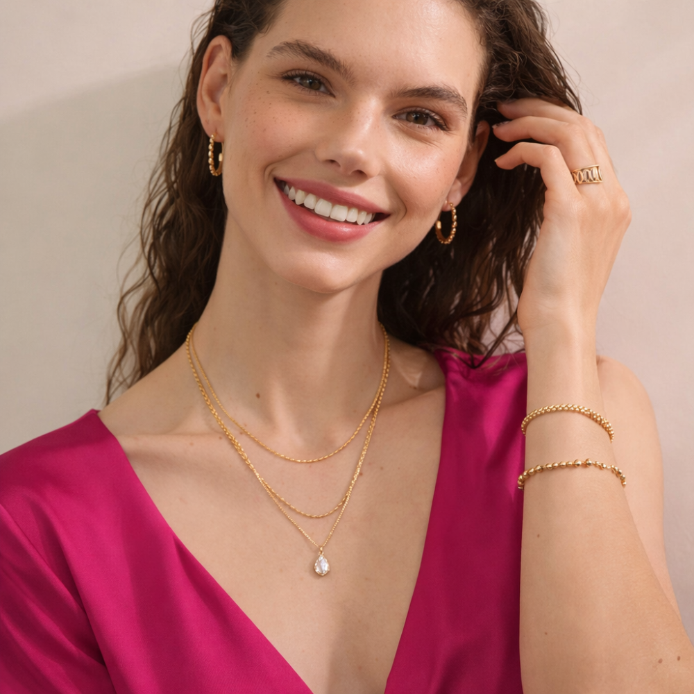 Gold layered necklace with a pendant.