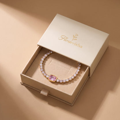 High quality Amara pink emerald-cut crystal tennis bracelet displayed inside an off-white Floravisha luxury sliding jewelry gift box.