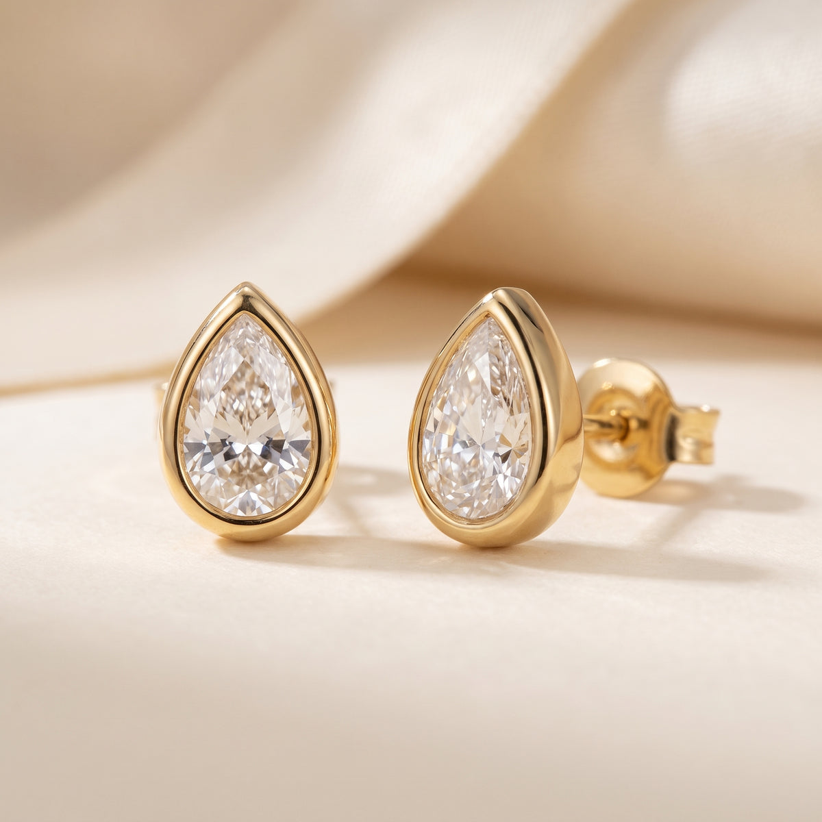 High quality Delphine Petite gold teardrop stud earrings by Floravisha showing snag-free bezel cups, faceted crystals, and surgical steel posts.