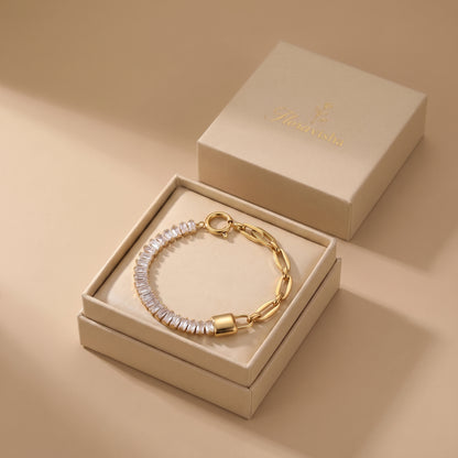 High quality Elysée gold baguette paperclip lock bracelet presented inside an off-white Floravisha luxury sliding jewelry gift box.