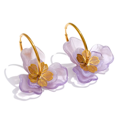 Pair of earrings with gold floral designs on a white background. latest earring models and trending earrings models. new arrivals.