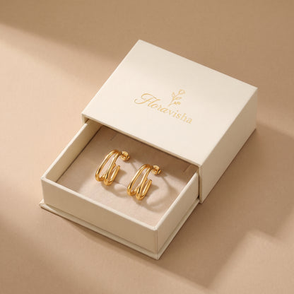 High quality Vienne gold double oval hoop earrings presented inside an elegant off-white Floravisha luxury sliding jewelry gift box.