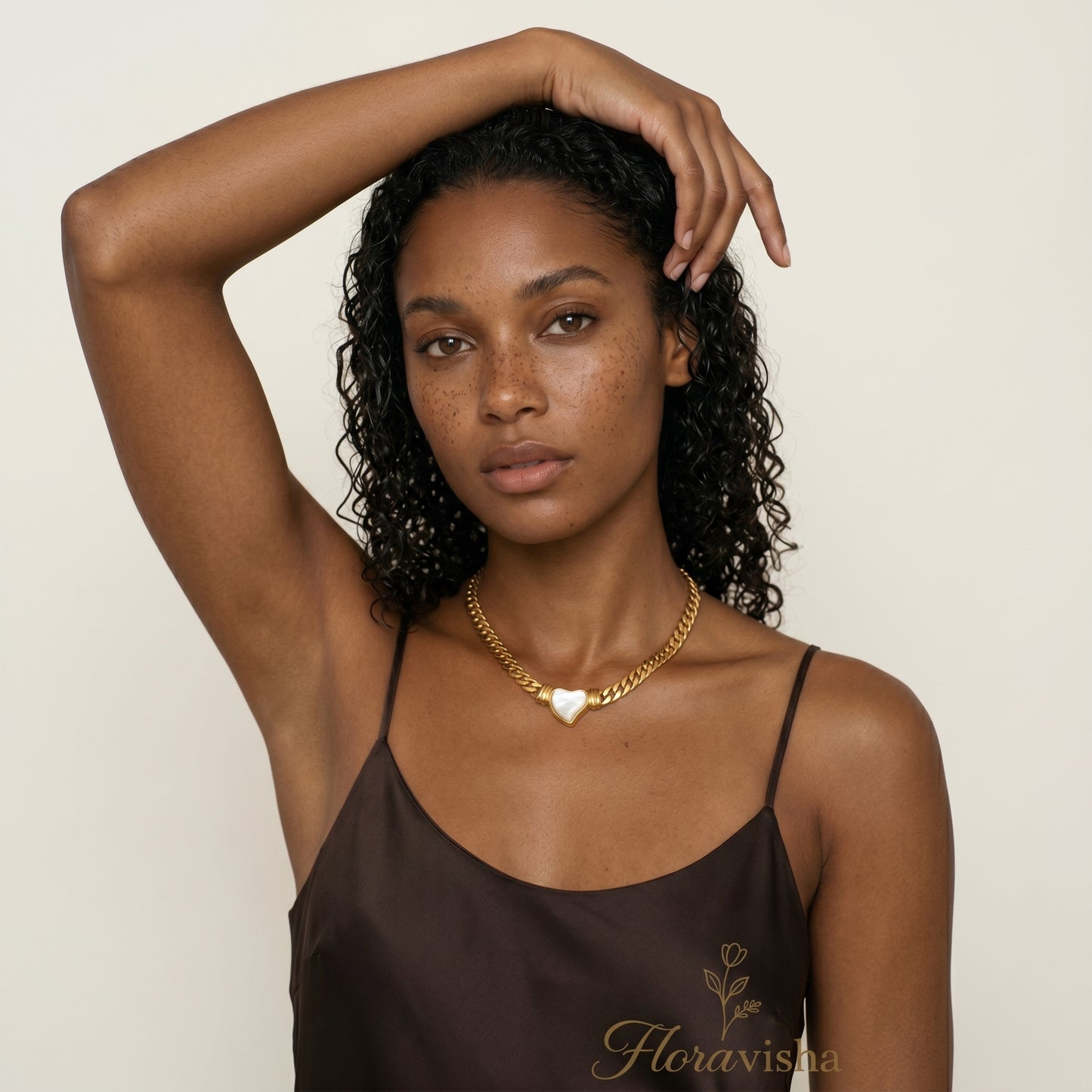woman wearing gold heart pendant choker necklace minimalist elegant jewelry close-up