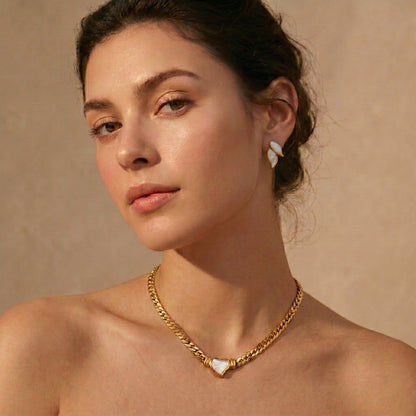 woman wearing gold heart pendant choker necklace with floravisha earrings