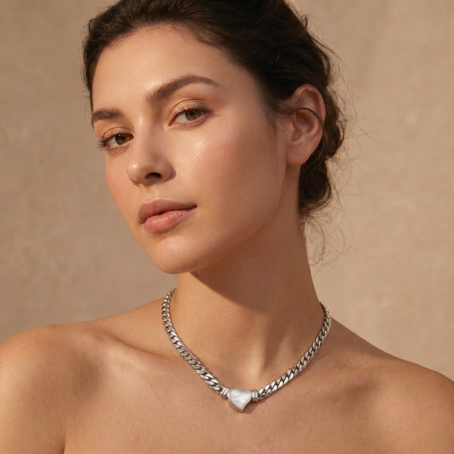 woman wearing silver heart pendant choker necklace minimalist elegant jewelry close-up